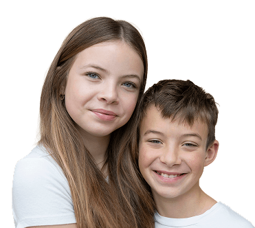 Young boy with short dark curly hair, wearing a green polo shirt and navy backpack, smiling gently.