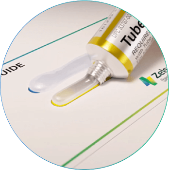 Squeezing equal amounts of ZELSUVMI gel from Tube A and Tube B onto the Dosing Guide