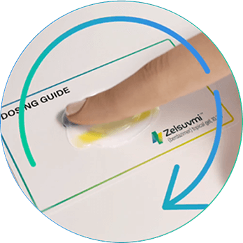 Using a fingertip to mix ZELSUVMI gels on the Dosing Guide before application